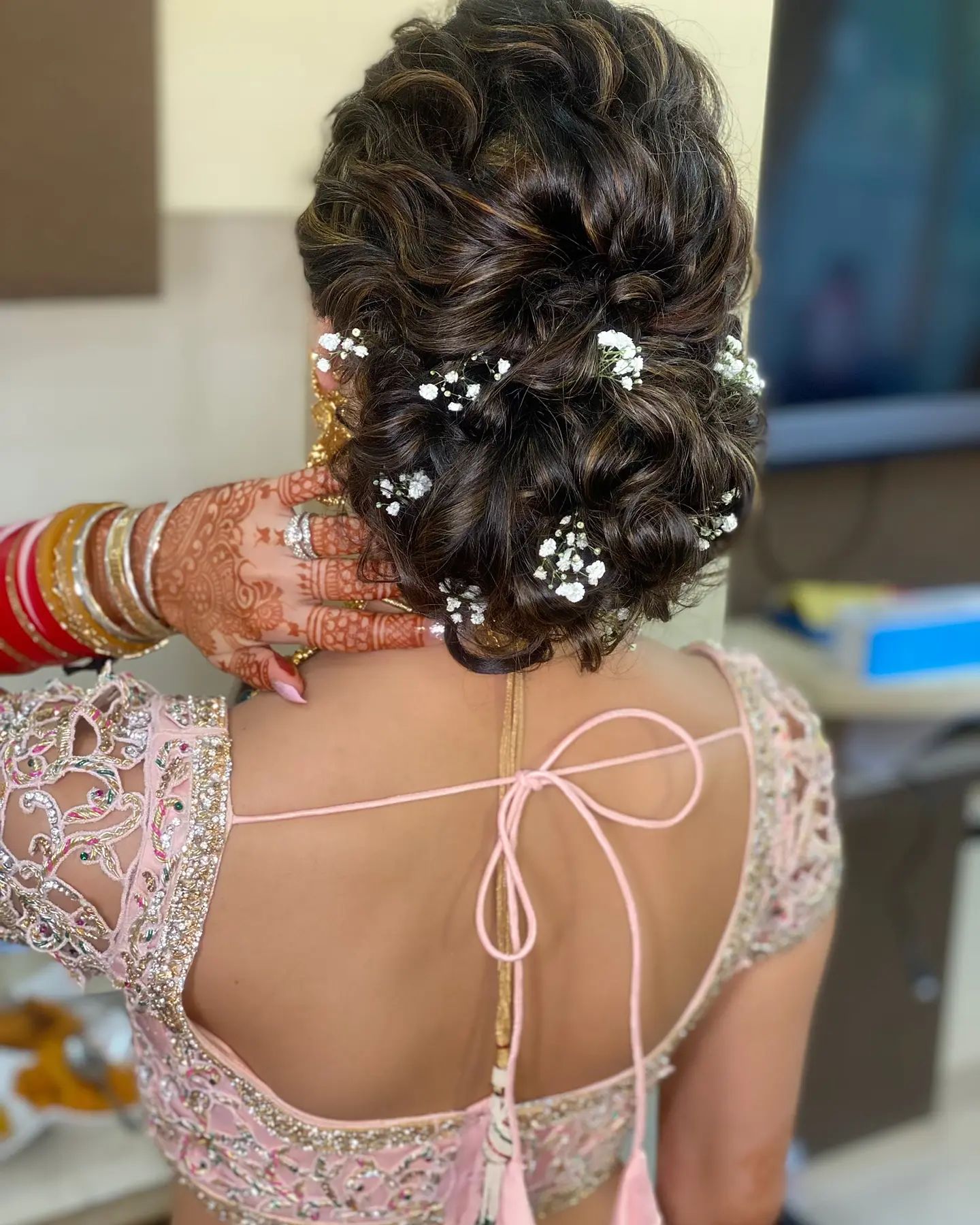 side-bun-hairstyle-for-engagement-in-lehenga | WedAbout