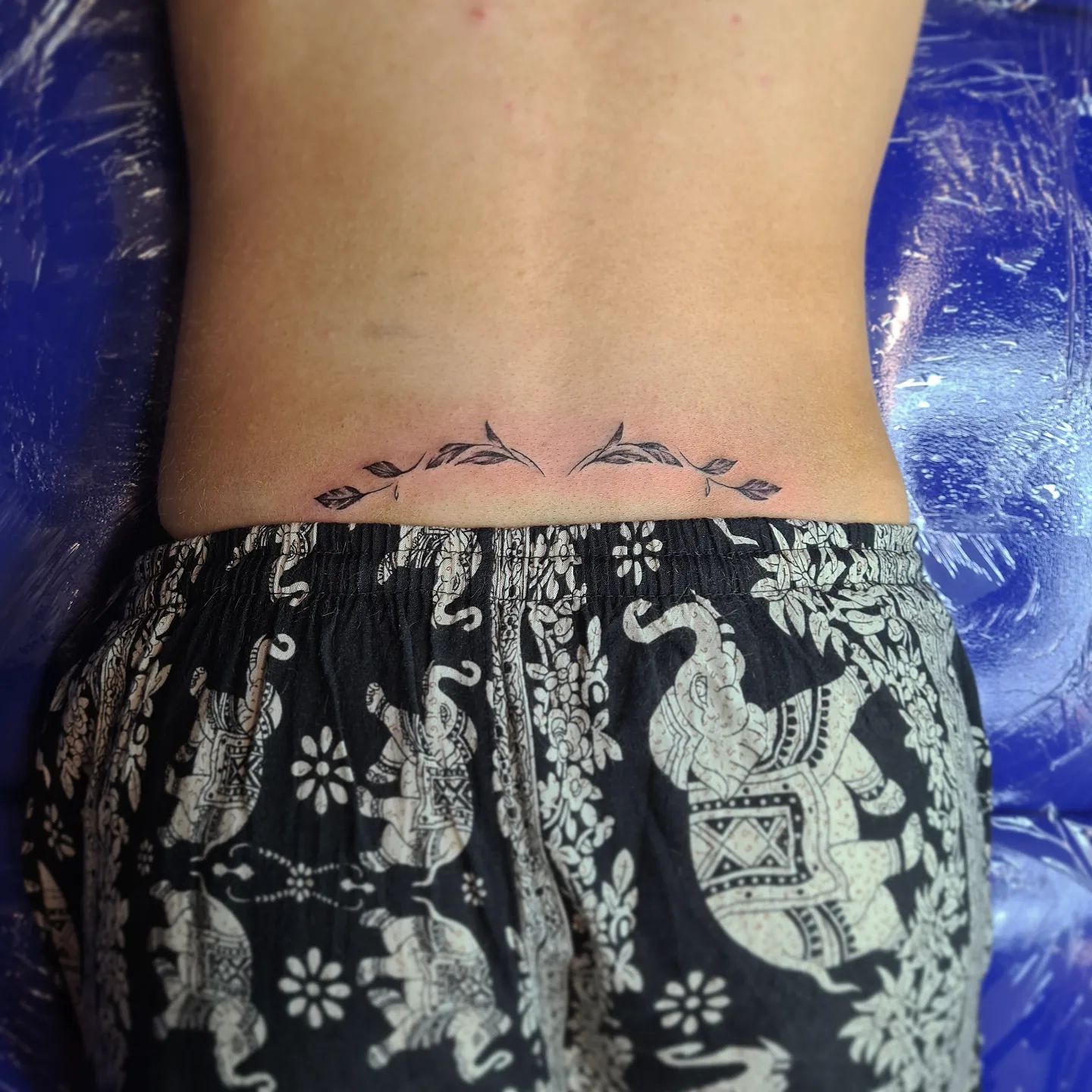 lower back flower coverup tattoo by Stefano Alcantara TattooNOW