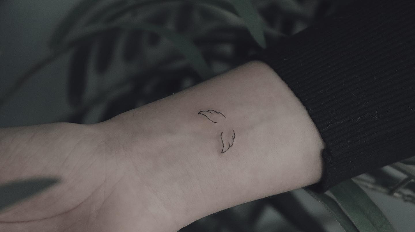 Tiny Angel Wings Tattoo On Wrist
