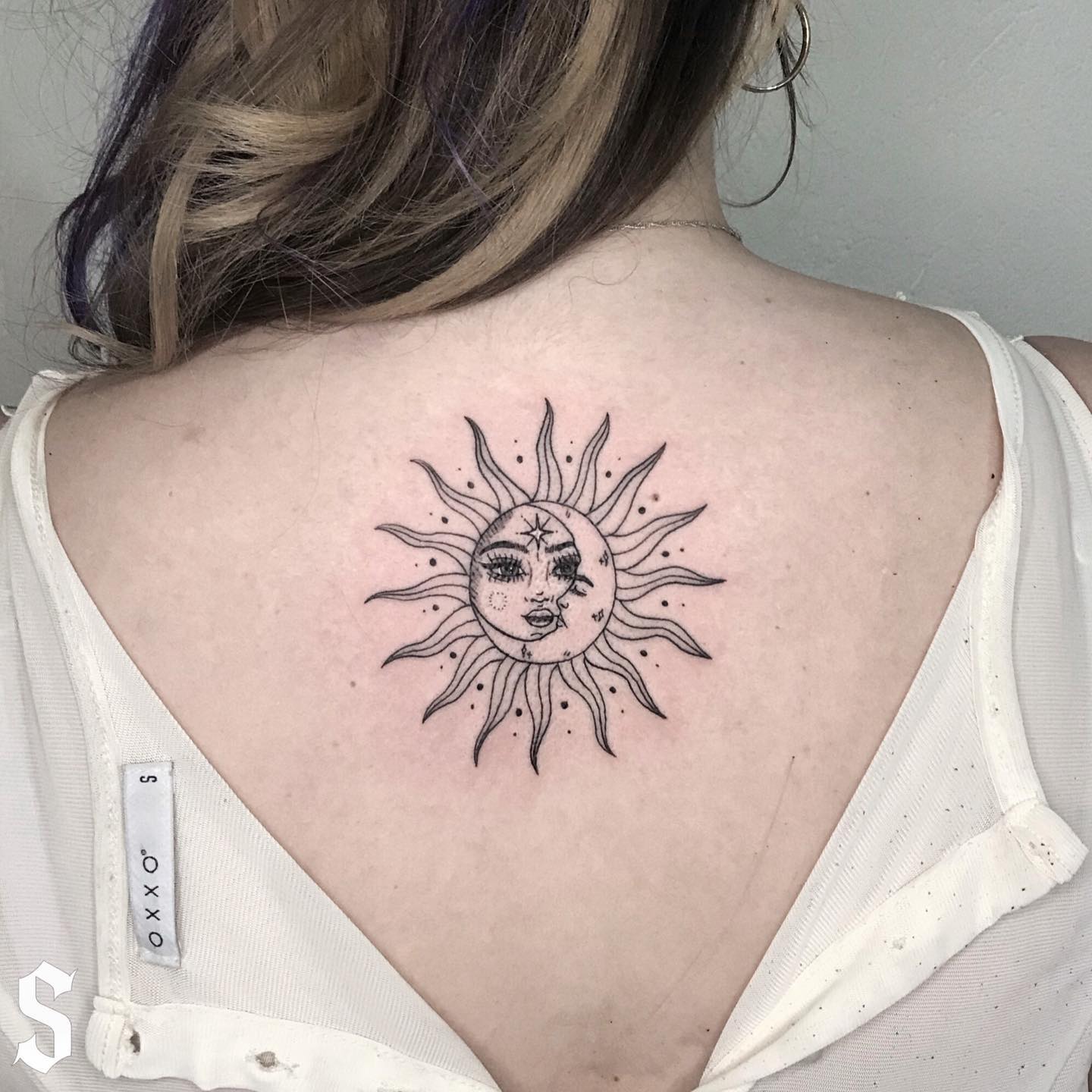 Tiny Sun Tattoo On upper Back Of Girl