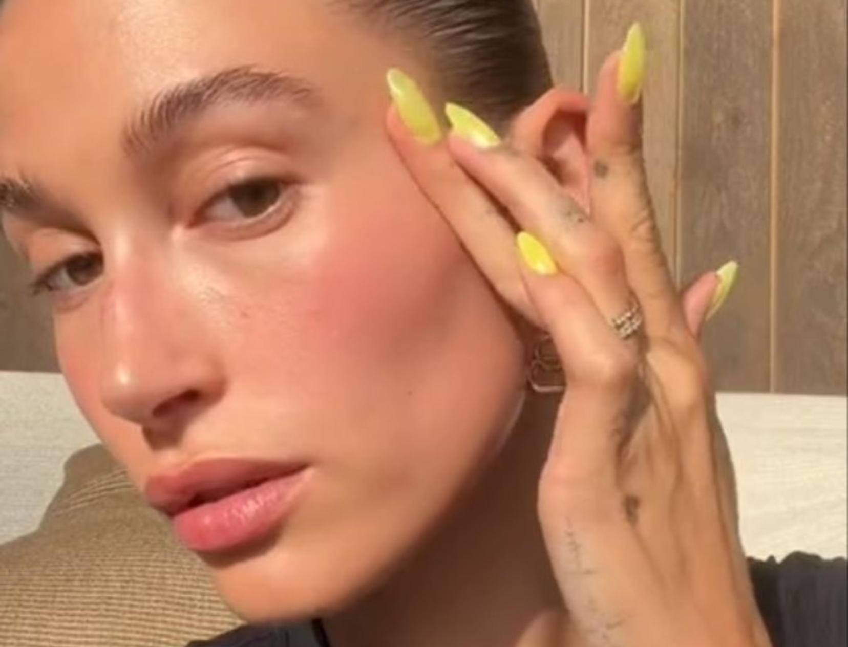 hailey bieber applying makeup